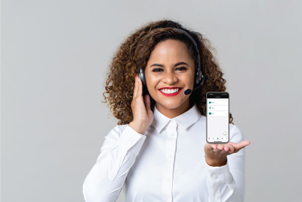 woman holding a phone and using a headset microphone